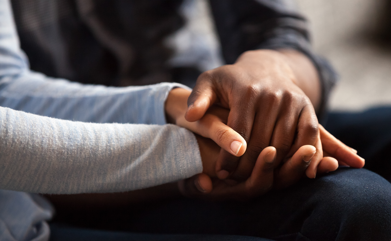 Two people holding hands